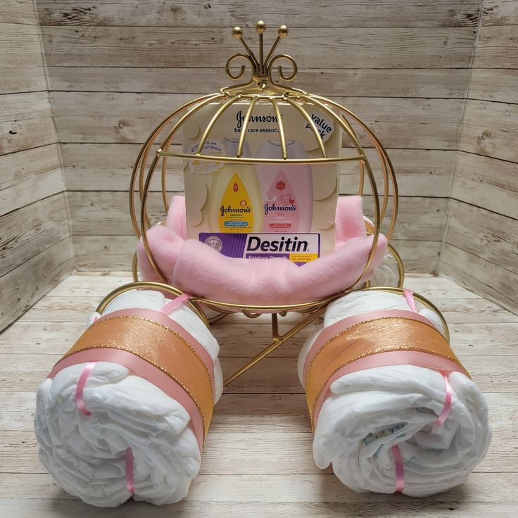 two baby diapers in a gold birdcage