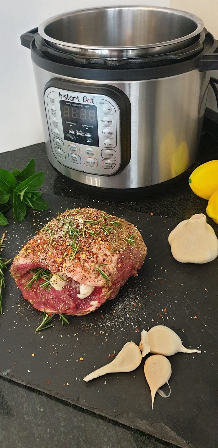 a piece of meat sitting on top of a counter next to an instant pot