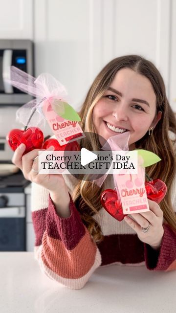 a girl holding up some candy in her hands