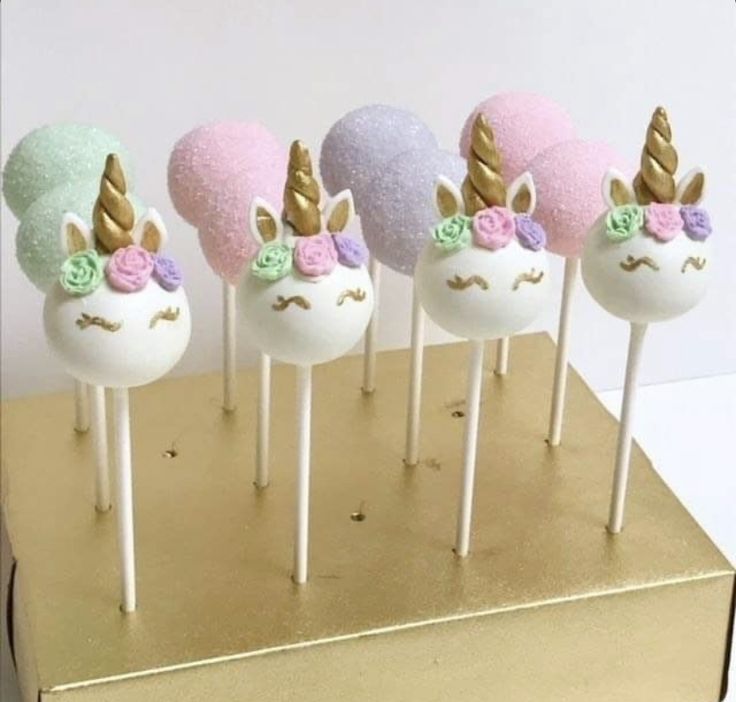 the cake pops have unicorn ears on them