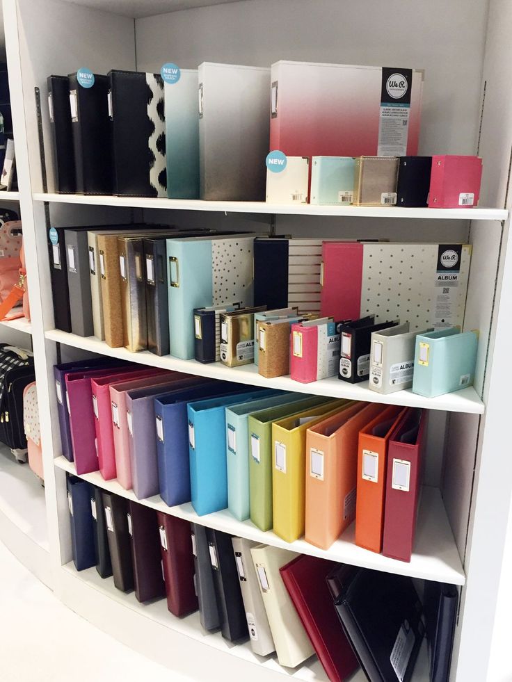 a book shelf filled with lots of books and binders on top of each other