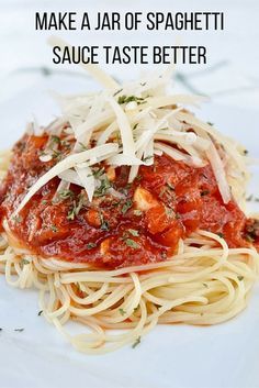 a white plate topped with spaghetti and sauce