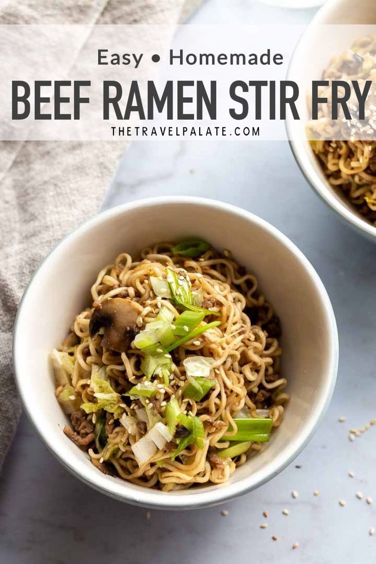 two bowls filled with noodles and vegetables on top of a white countertop next to a napkin