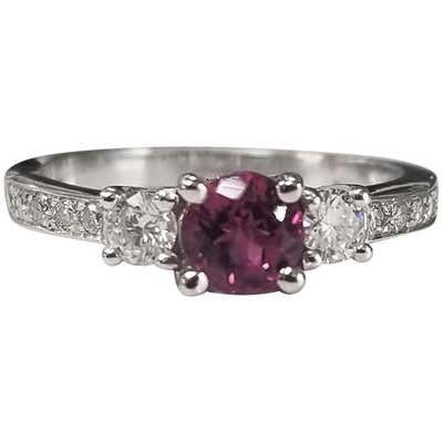 an oval shaped pink sapphire and diamond three stone ring