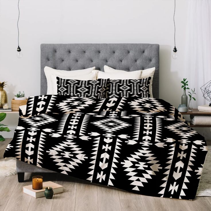 a bed with a black and white pattern on it