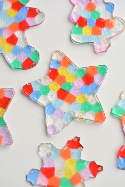 several decorated cookies are arranged on a white surface with multicolored squares and shapes