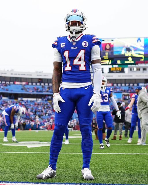 a football player standing on top of a field