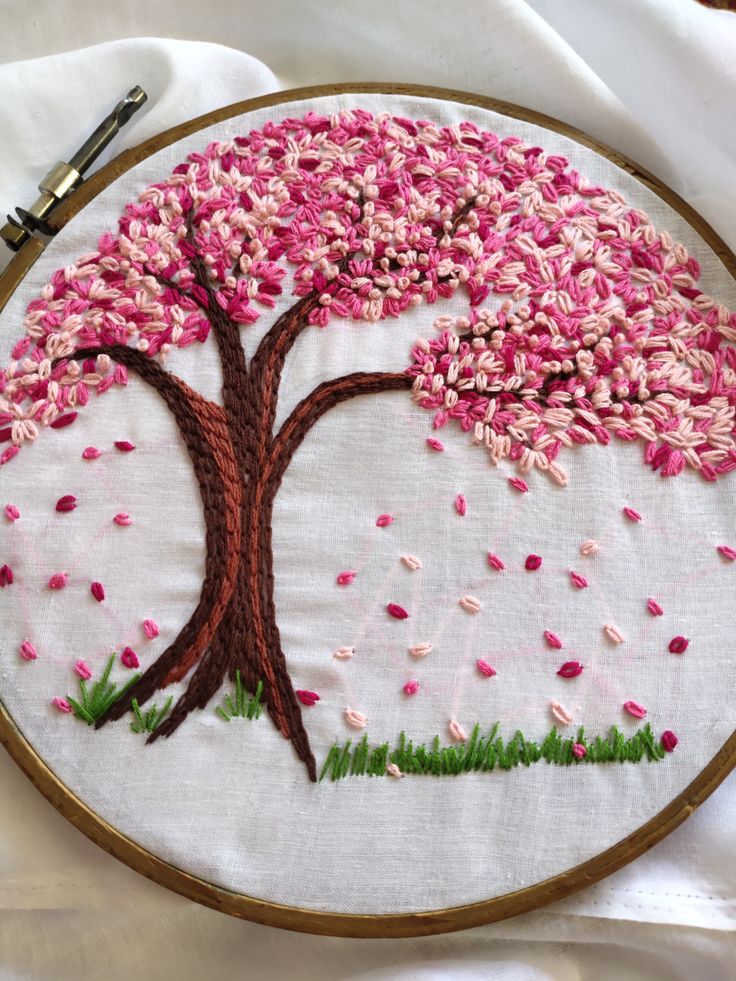 a hand embroidered tree with pink and white flowers