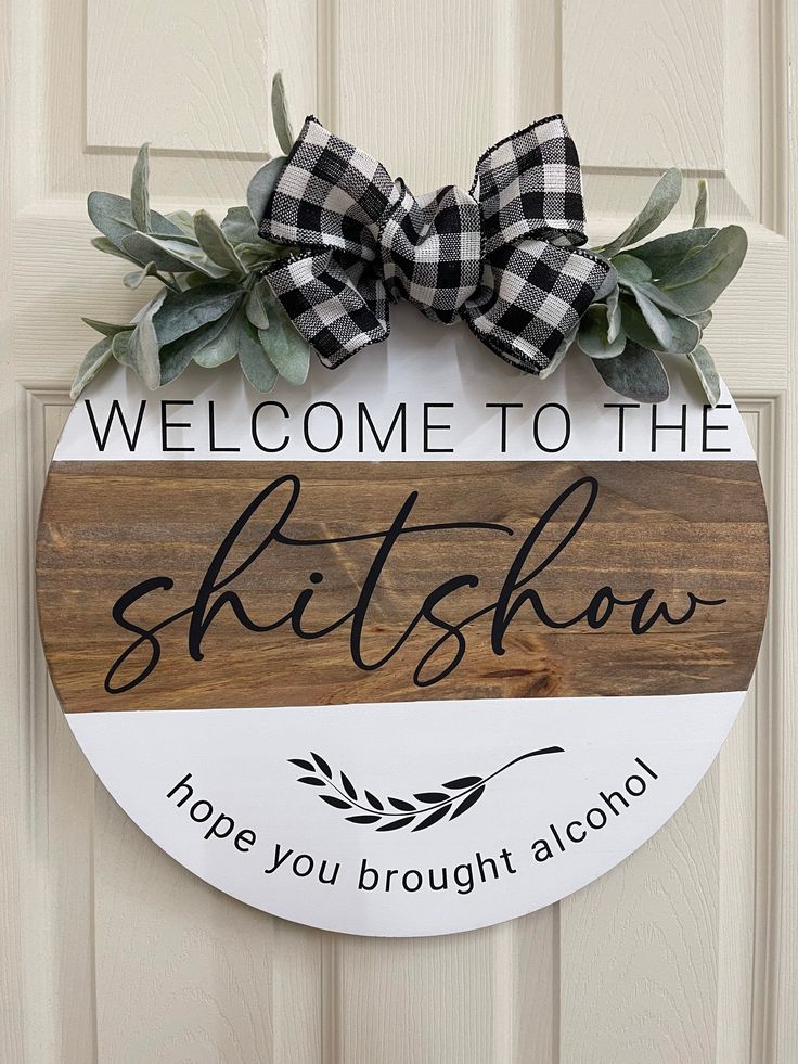 a wooden sign that says, welcome to the skitshow hope you brought alcohol