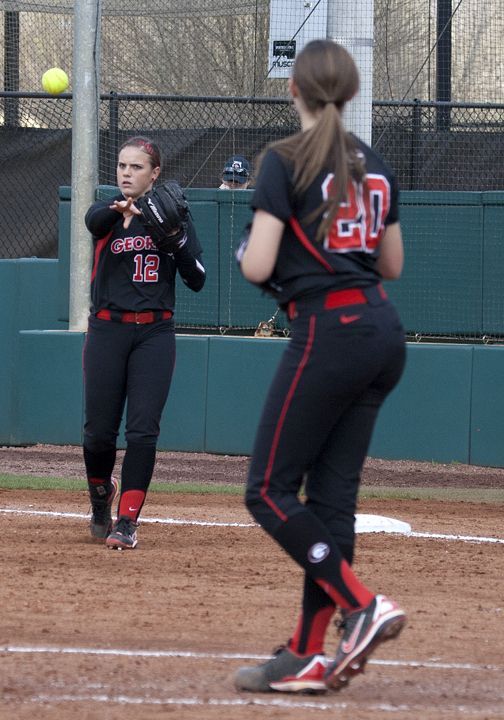 two softball players on the field during a game