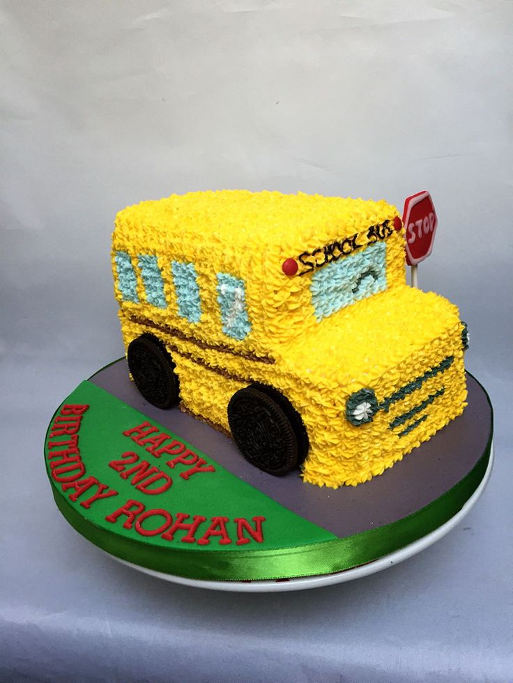 a cake made to look like a school bus on top of a green platter