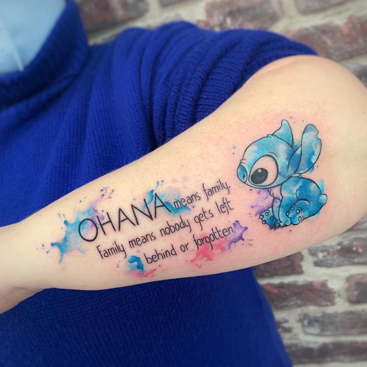 a person with a tattoo on their arm that says ohana, family means nobody gets left behind or forgotten