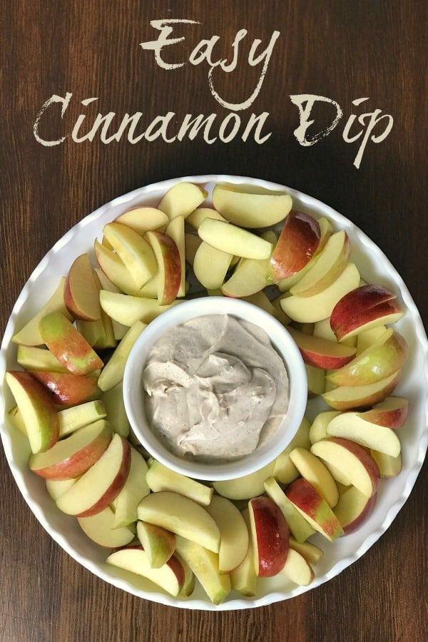 an apple slices and dip in a white bowl on a wooden table with the words easy cinnamon dip