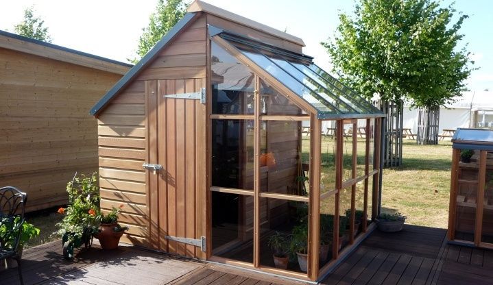 a small wooden building with a glass roof