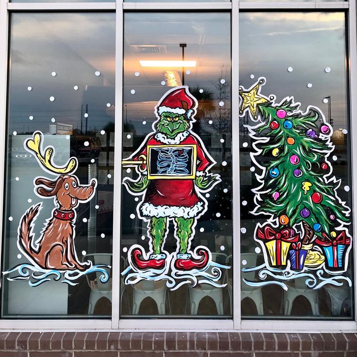 the window is decorated with christmas decorations and stickers