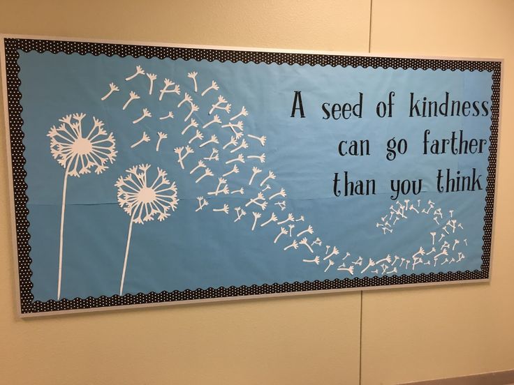 a blue sign with white dandelions on it that says, a seed of kindness can go farther than you think