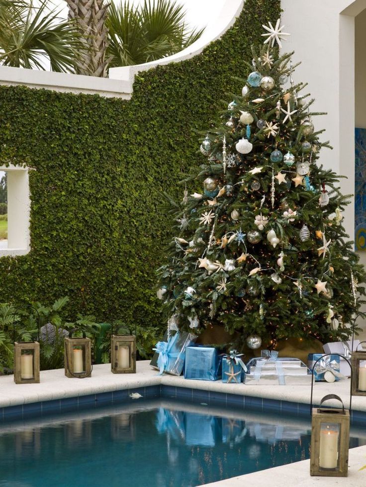 a christmas tree next to a swimming pool