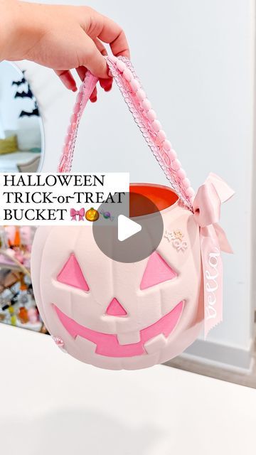 someone is holding a trick - or - treat bucket