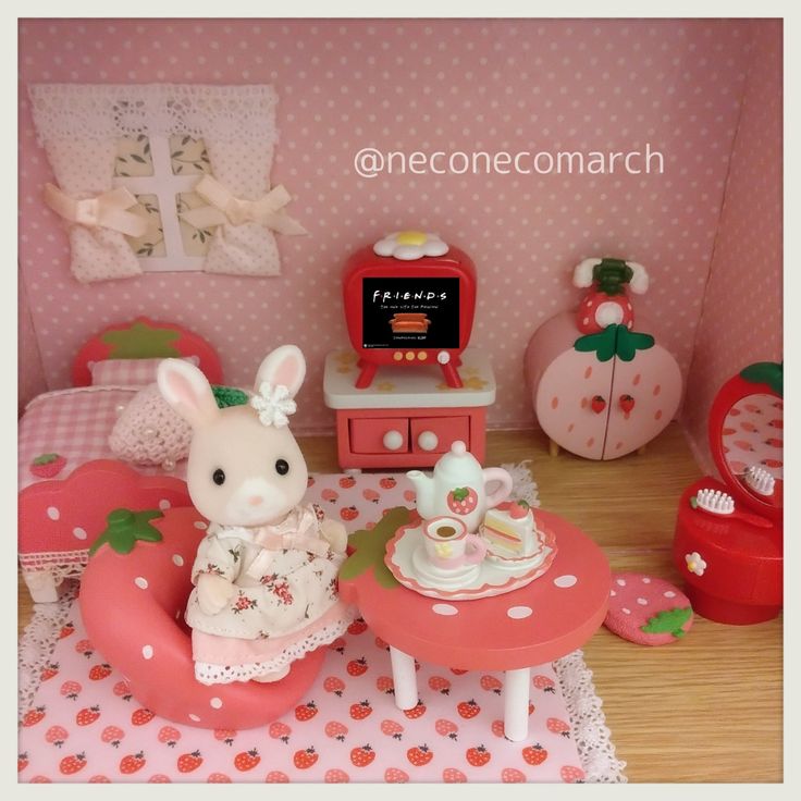 a doll house with pink furniture and accessories