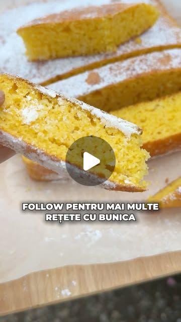 a person holding up a piece of cake with powdered sugar on it and the words follow pentru mai multe retete cu bunica