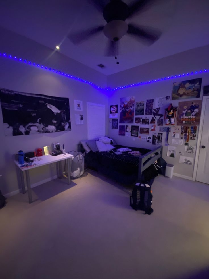 a bedroom with purple lighting and pictures on the wall