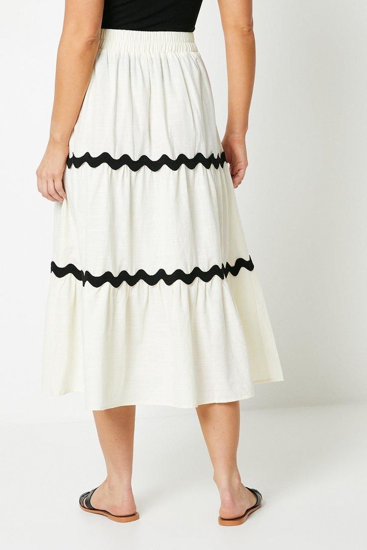 Tiered maxi skirt crafted from cotton linen blend
Flattering A-line silhouette with a flowy, tiered design
Contrasting ric-rac trim adorns the tiers for a playful touch
Elasticated waistband ensures a comfortable, flexible fit
Midi length hits below the knee for effortless coverage
Embrace a breezy, feminine aesthetic with this tiered maxi skirt. The lightweight linen blend fabric drapes beautifully, while the flared A-line shape and tiered design create a flattering, flowy silhouette. Contrast ric-rac trim adds a playful, eye-catching detail. Pair it with a simple tank or tee for a casual daytime look, or dress it up with a camisole and sandals for a chic warm-weather ensemble perfect for family gatherings or weekend outings. Tiered Maxi Skirt, Oasis Fashion, Ric Rac, Feminine Aesthetic, Draped Fabric, Family Gatherings, Fashion Face, Cotton Linen, Warm Weather