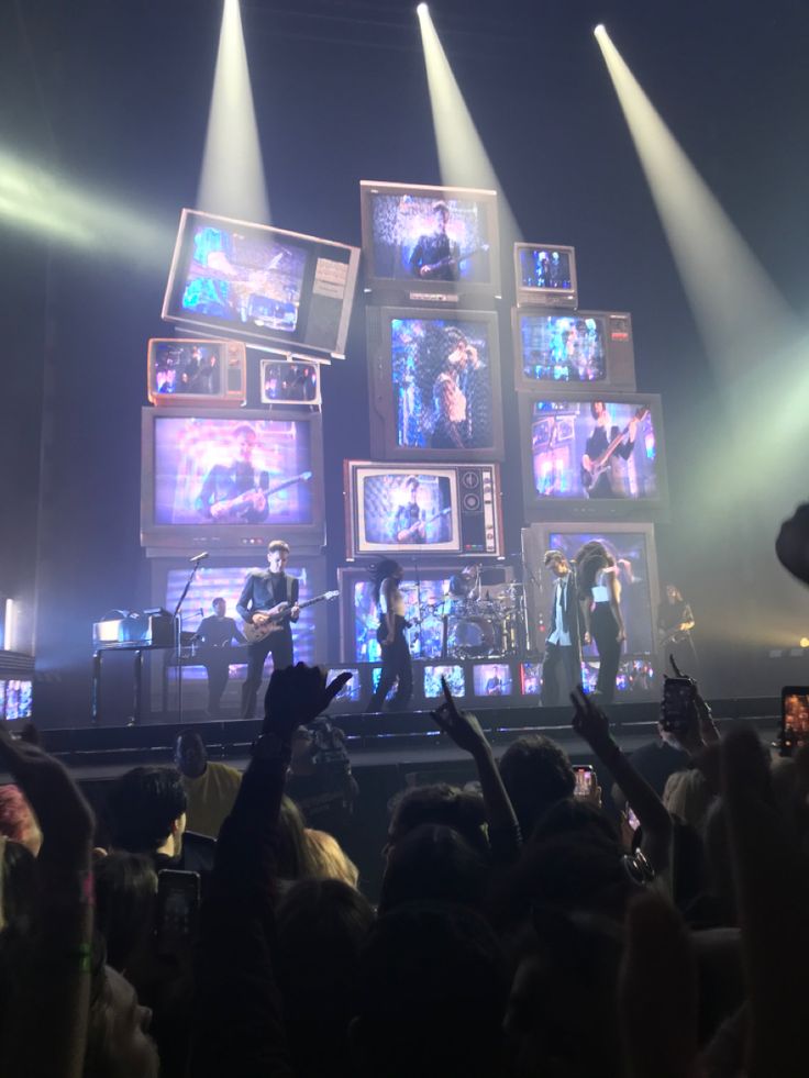 a group of people standing on top of a stage