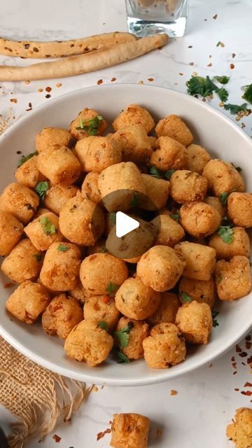 a white bowl filled with tater tots on top of a table