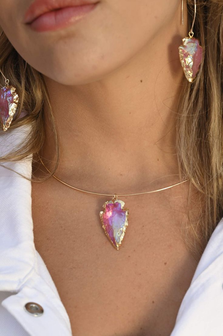 Another version of our most-loved gold choker with arrowhead pendant, this Pink Aura necklace is the most beautiful pink choker! Wear this with our beautiful Heart Work Earrings (as seen in photos) and remember that your "Heart Work" is to be authentically you. Wear this beauty with their matching Pink Aura Earrings as seen in photos. Pink Aura Quartz connects to all of the body's Chakras. It holds a potent, dynamic energy that uplifts, enhances, and brings out your true essence. Pink Aura Quart Pink Aura Quartz, Aura Necklace, Work Earrings, Arrowhead Pendant, Quartz Choker, Pink Choker, Handmade Crystal Jewelry, Boho Layering, Pink Aura