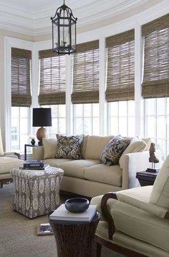 a living room filled with furniture and windows