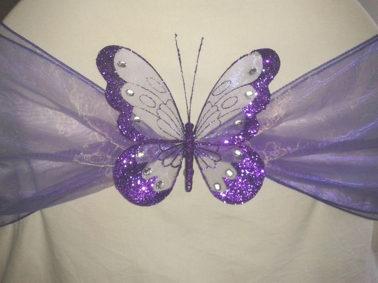 a purple butterfly with sequins on it's wings