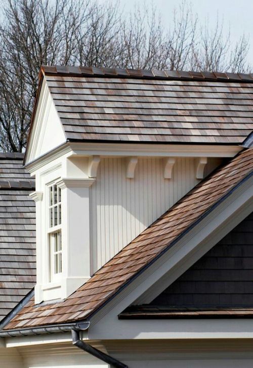 the roof of a house with shingles and windows