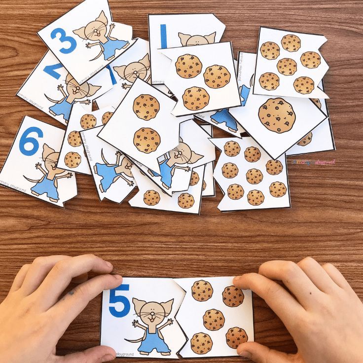 someone is playing with the numbers and counting cards for their children to learn how to count them