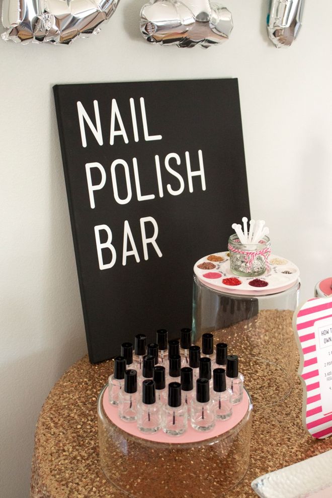 there is a nail polish bar with bottles on the counter and other items around it