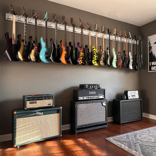 guitars and amps are lined up on the wall