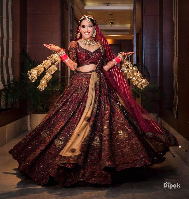 a woman in a red and gold lehenga