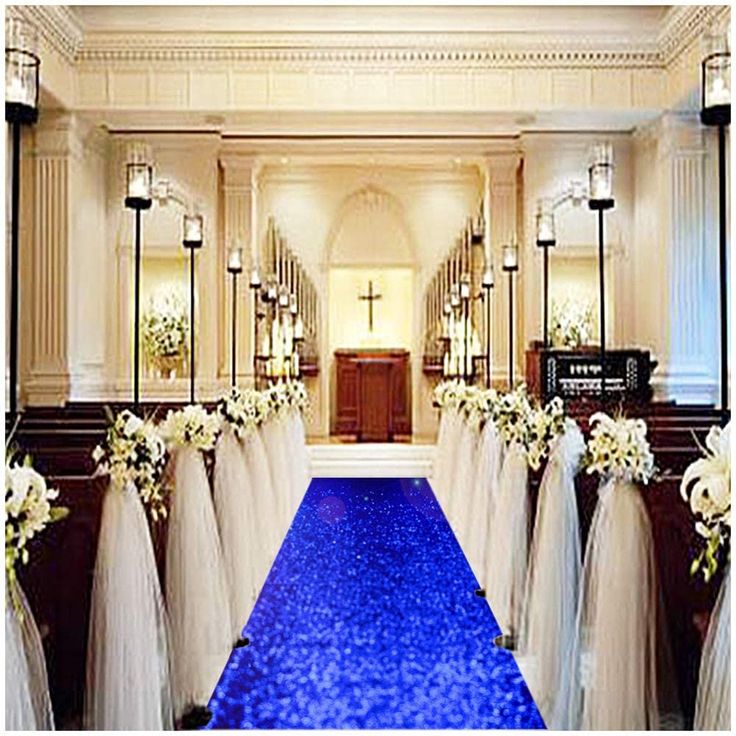 the aisle is decorated with white flowers and purple carpet