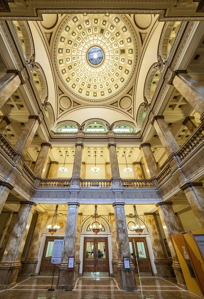 the inside of a large building with columns and a dome on it's ceiling