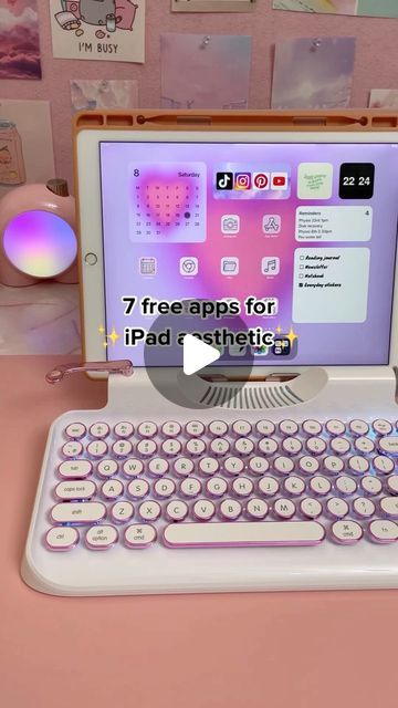 an open laptop computer sitting on top of a pink desk next to a mouse and keyboard