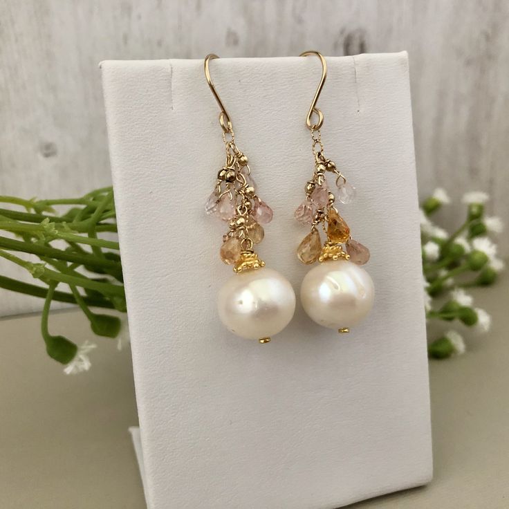 Gorgeous freshwater Pearl Drop Earrings. They are perfect in their simplicity and are incredibly elegant. There is a great deal of detail in these earrings, as you would expect from a Praha Jewelry Design piece. Description: 15mm white round pearls are suspended by 14K GF chain with pastel sapphire briollets. 2mm 14K GF seamless balls sit just above each briollet. All 14K GF and 24K vermeil components Briolette High Luster Pearl Earrings As Gift, Elegant Briolette Pearl Earrings, Briolette High Luster Pearl Earrings For Gift, High Luster Briolette Pearl Earrings As Gift, High Luster Briolette Pearl Earrings For Gift, Briolette Pearl Earrings With Pearl Charm As Gift, Briolette Pearl Earrings For Gift, White Akoya Pearl Earrings With Pearl Charm, Akoya Pearl Earrings With Ear Wire For Gifts