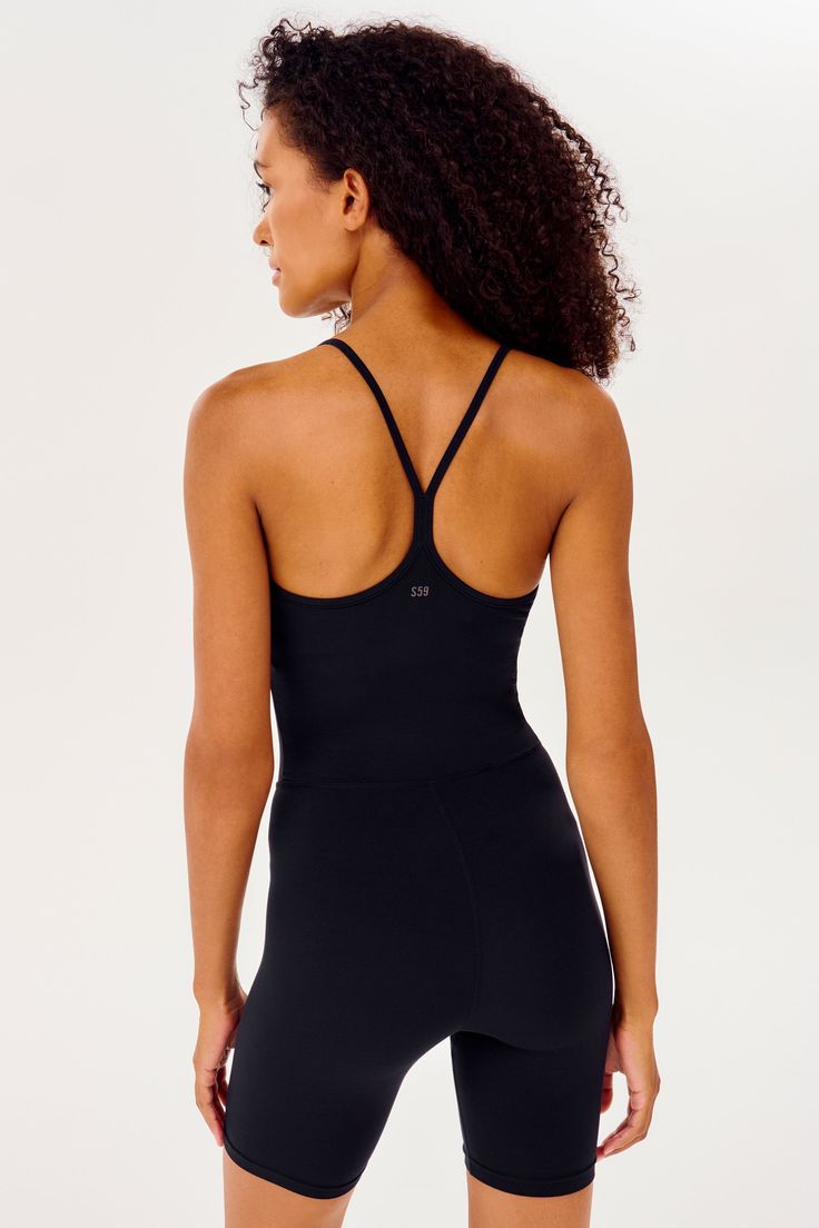 A body-hugging one piece jumper in a bike short length. Super soft Airweight fabric. Great for any workout or for casual wear. BEST FOR: hot yoga, barre, Pilates, court sports and cycling.Model Stats:Height: 5’10.5”, Bust: 32", Waist: 24”, Hips: 34” Wearing size: Small Sleek Yoga Activewear With Built-in Bra, Athleisure Bodysuit With Built-in Bra For Pilates, High Stretch Sports Unitard With Built-in Bra, Compressive Seamless Unitard For Yoga, Compressive Seamless Yoga Unitard, Sporty Unitard With Built-in Bra For Gym, Sleek Black Bodysuit For Workout, Sleek Activewear With Built-in Bra For Gym, Sleek Gym Activewear With Built-in Bra