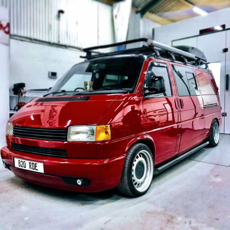 a red van is parked in a garage