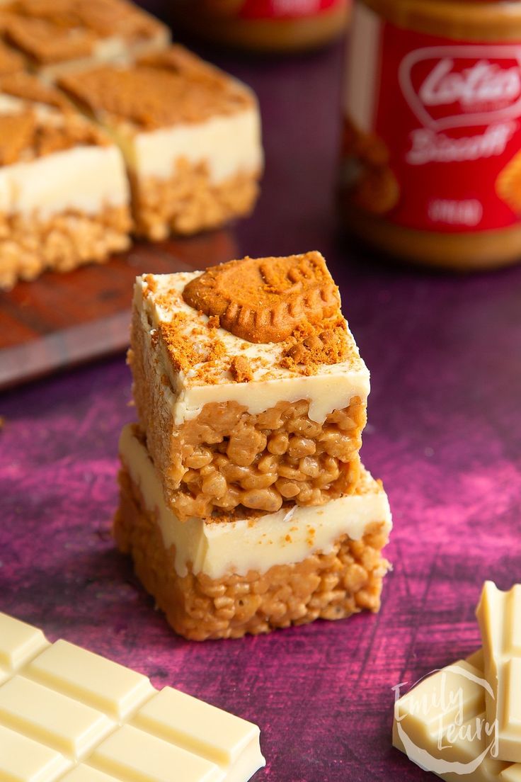 three pieces of cake sitting on top of a table next to peanut butter and jelly