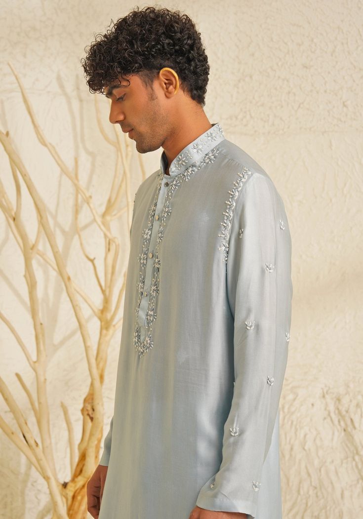 Featuring a stylish Powder Blue Chanderi Silk Kurta Set, complemented by metallic silver buttons that add a touch of grace. Teamed with matching pants for an elegant look, this ensemble is perfect for an engagement, Roka or Sangeet, blending sophistication with contemporary charm. Composition : Chanderi Silk Care: Dry Clean Only and Vacuum Storage This product can be customized for sleeves, length and colour Delivery : 4-6 weeks as the product is hand crafted. Check Size Guide or choose MySize for free customisation (All Sizes above XL can be made at 15% additional cost) For more information and sizes please contact fabiliciousfashion@gmail.com or visit our Copenhagen studio. About the Designer : Shreyansh, a distinguished designer label specializing in luxurious ethnic menswear for weddin Full Sleeve Kurta, Silk Kurta Set, Placement Embroidery, Kurta Set For Men, Indian Wedding Wear, Silk Kurta, Silk Embroidery, Kurta Set, Wedding Wear