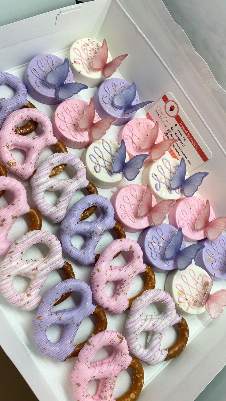 a box filled with donuts covered in frosting and sprinkles