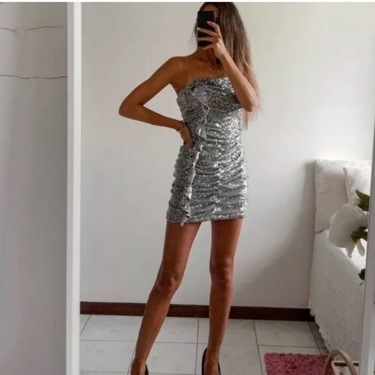 Hard To Find Silver Strapless Summer Dress, Silver Strapless Dress For Summer, Silver Strapless Sequin Dress For Party Season, Silver Strapless Mini Dress For Night Out, Silver Strapless Party Dress, Glamorous Silver Mini Dress, Silver Mini Dress For Date Night, Metallic Silver Mini Dress For Night Out, Silver Chic Fitted Sequin Dress