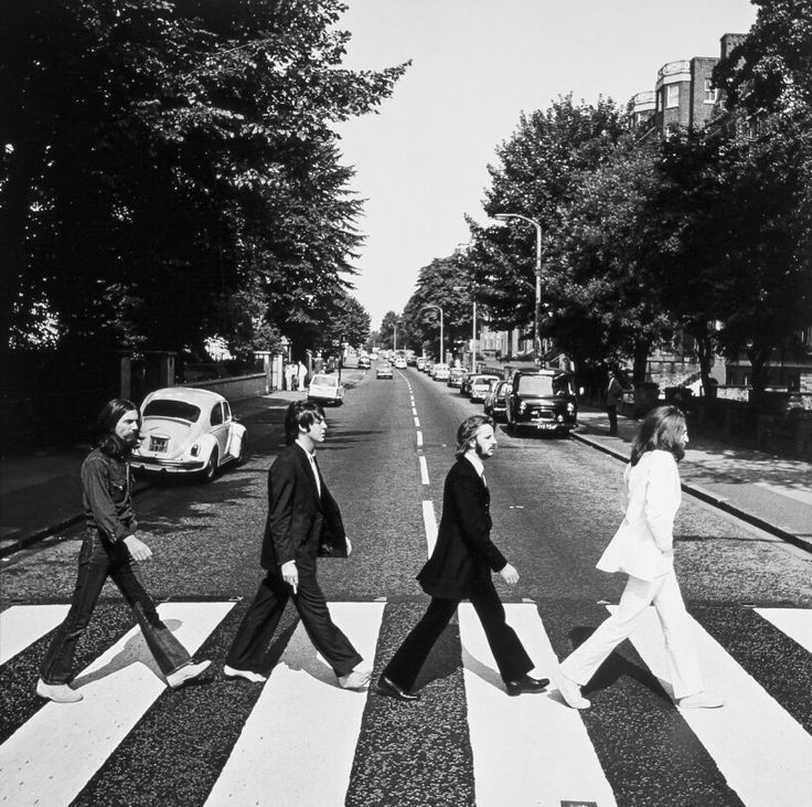 the beatles crossing the street at an intersection