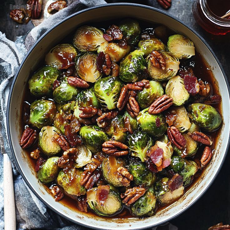 brussel sprouts with pecans and maple syrup in a pan on a table