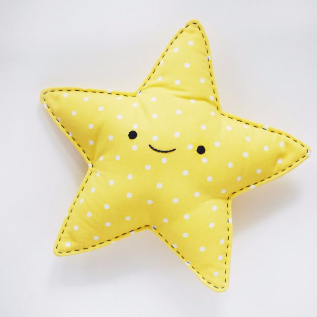 a yellow star pillow with white polka dots