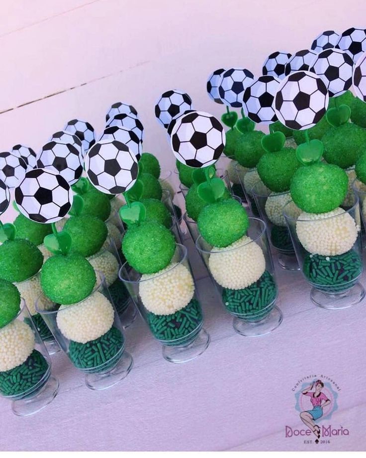 there are many cupcakes with soccer balls on them in the shape of cactuses